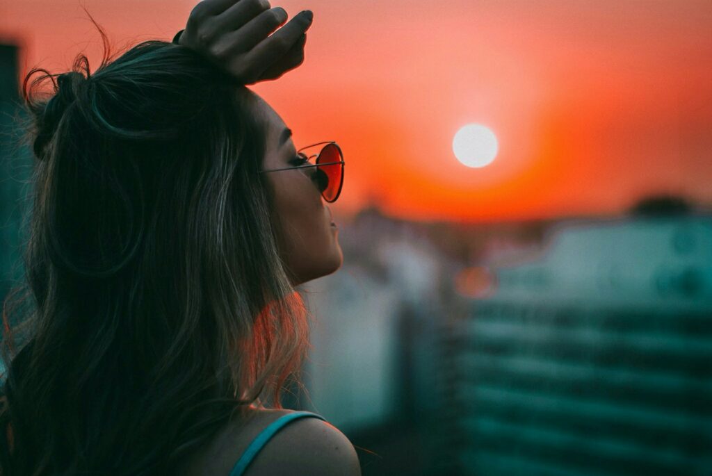 woman putting her left arm on her forehead
