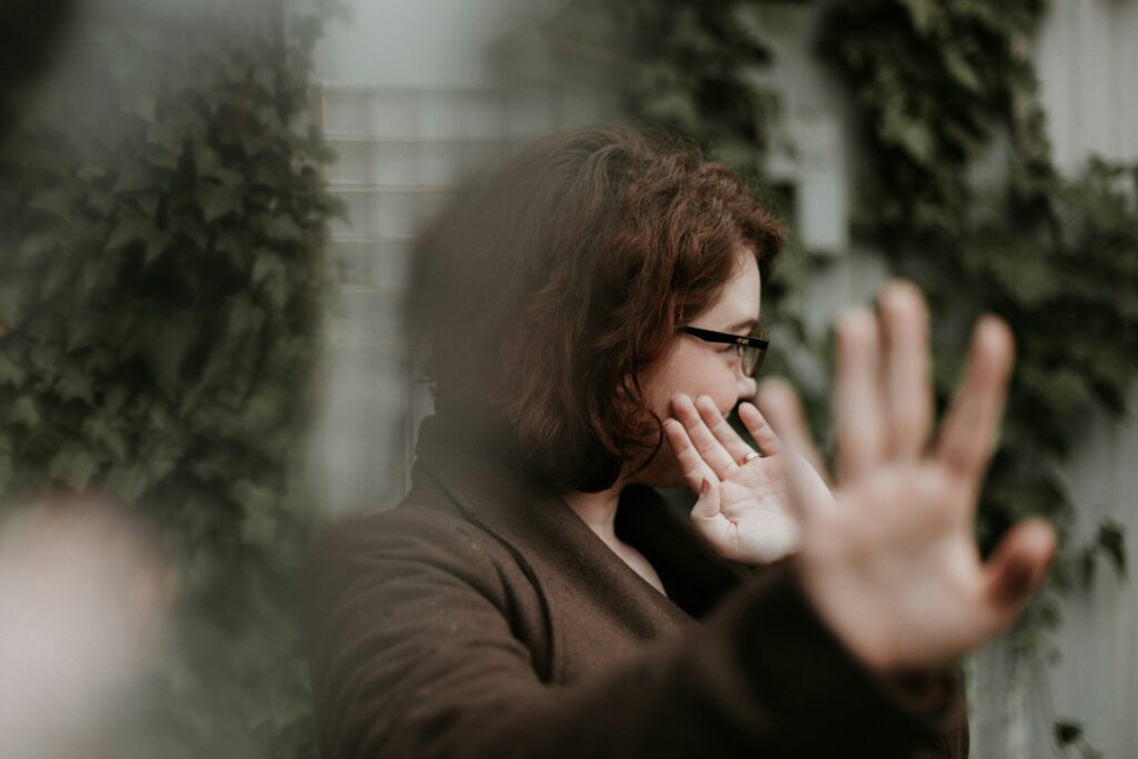 woman in brown sweater wearing black framed eyeglasses
