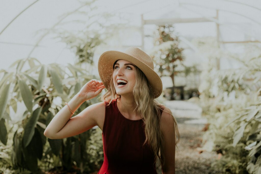 smiling woman wearing red sleeveless dress
