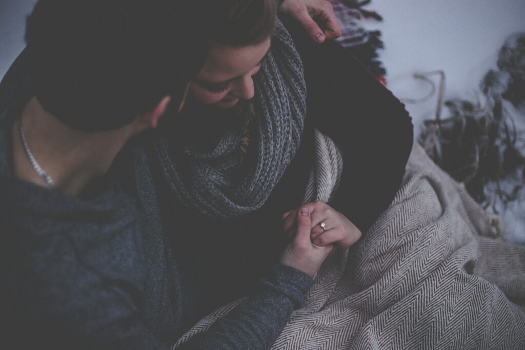 couple with grey blanket
