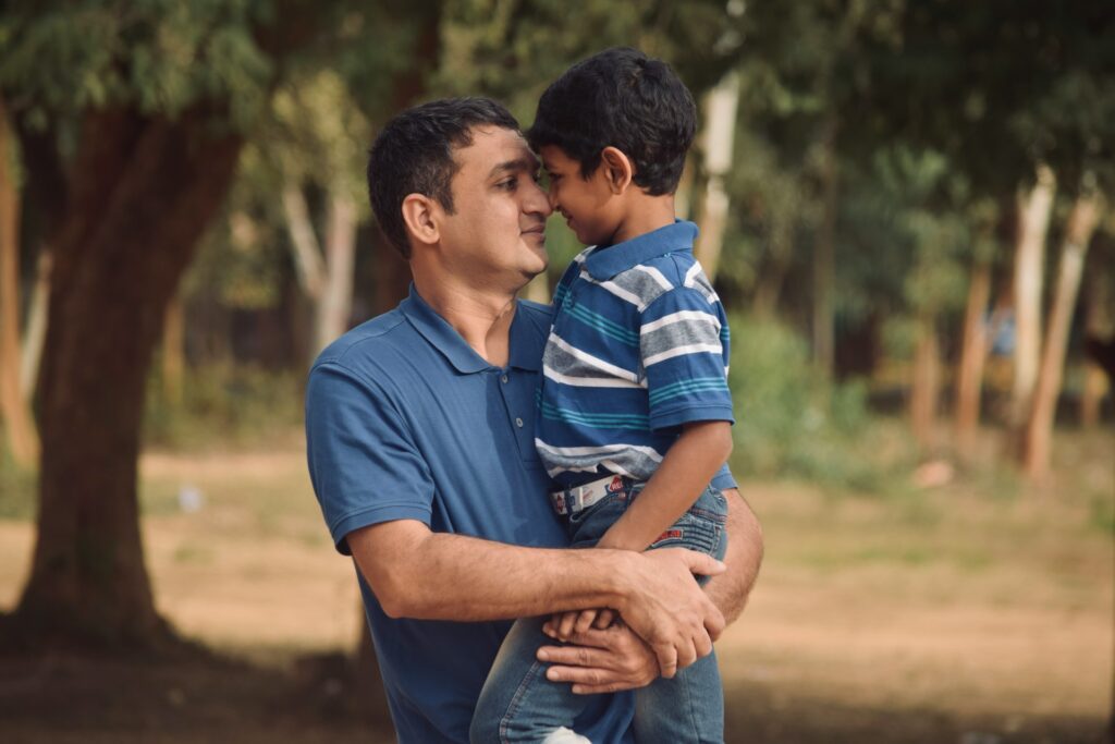 man in blue polo shirt holding man in blue and white polo shirt
