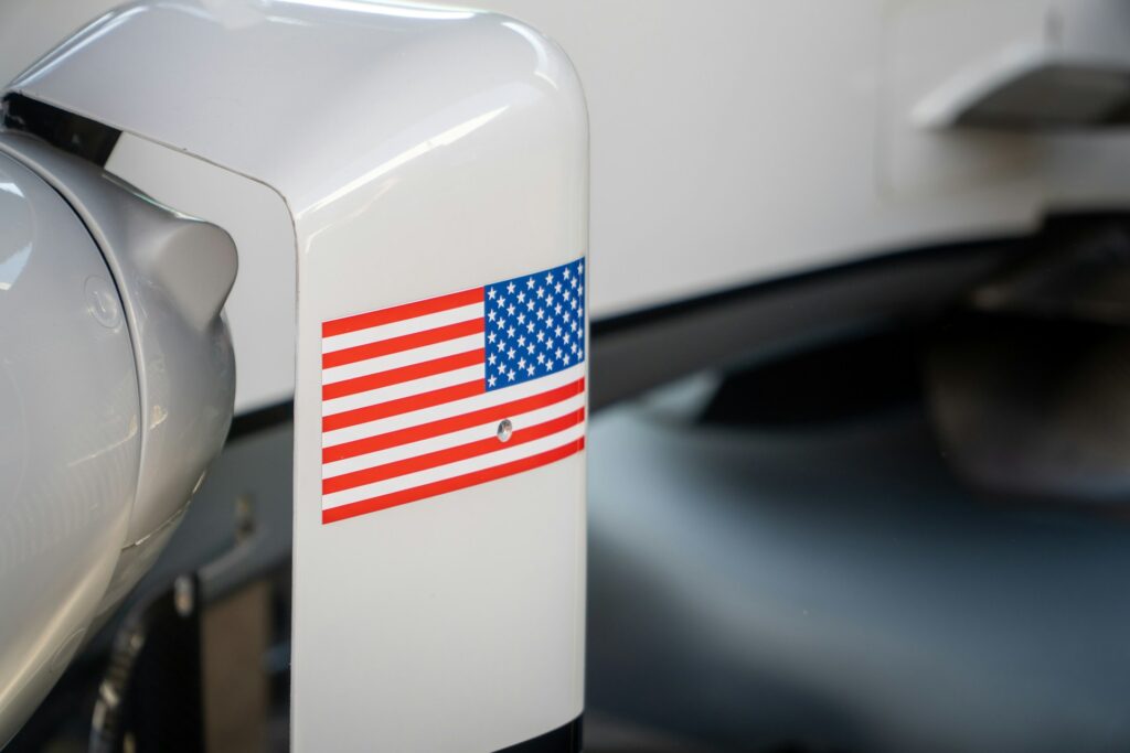 An american flag sticker is on a white surface.
