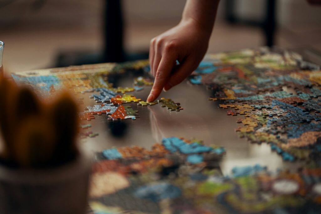 person holding jigsaw puzzle piece
