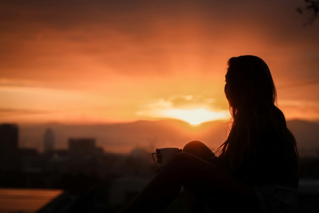 silhouette of woman during sunset
