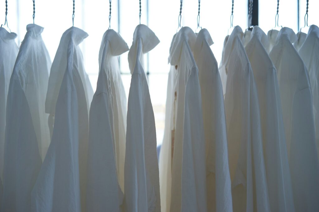 white dress shirt hangign on clothes
