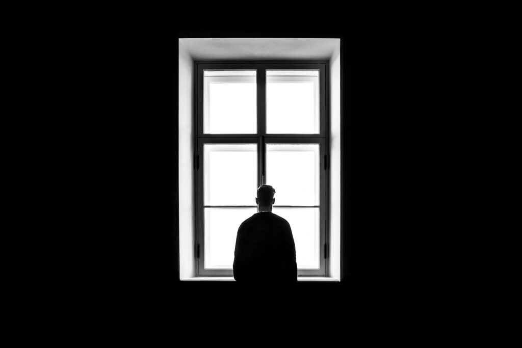 man standing in front of the window
