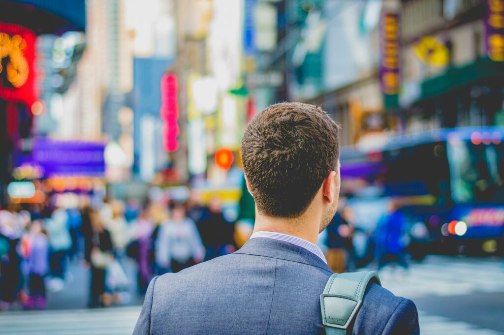 shallow focus photography of man in suit jacket's back
