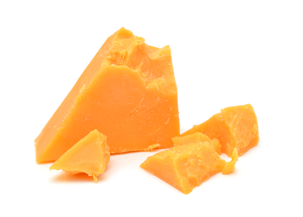 Cubes of cheddar cheese isolated on white
