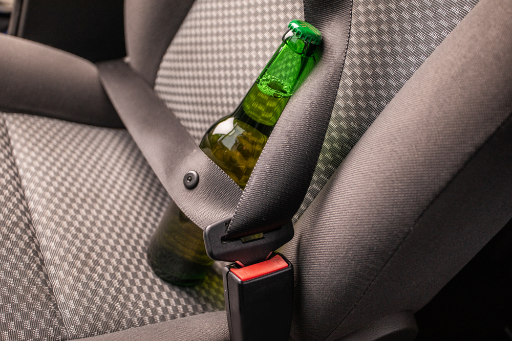 Drink and drive. Bottle of beer inside the car. Don't Drink for Drive
