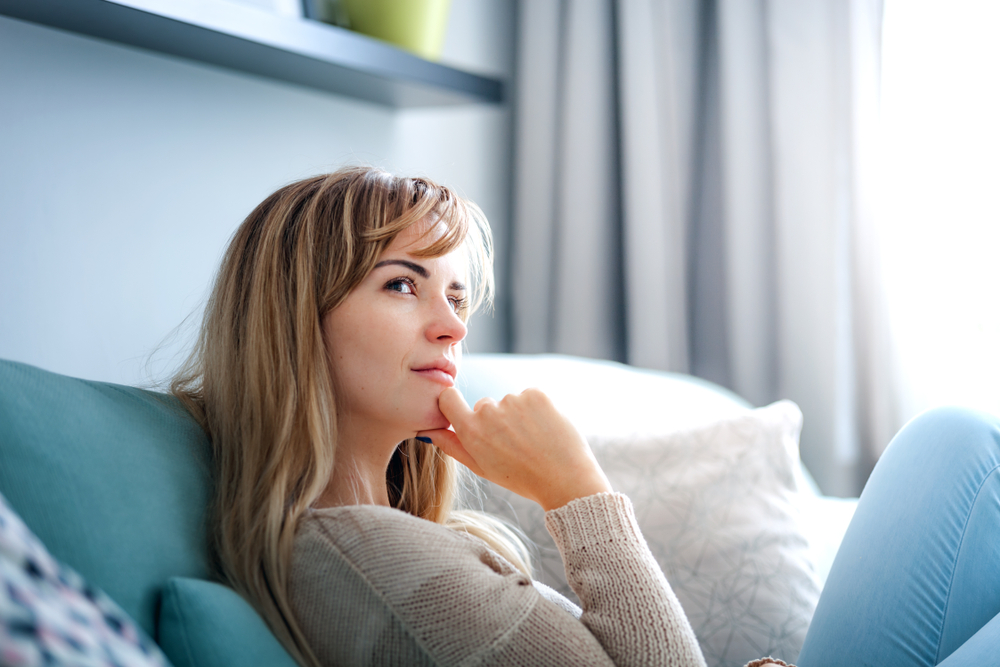 Woman at home deep in thoughts thinking and planning