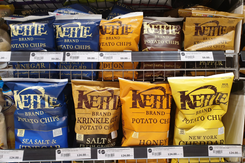 BANGKOK, THAILAND - APR 7, 2019: Kettle brand of flavoured chips and snacks on store shelf in Siam Paragon Mall. Kettle Foods is an international manufacturer of potato chips.
