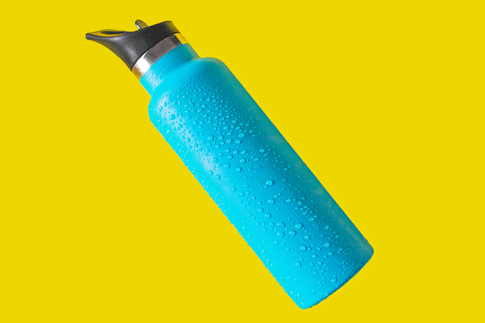 top view thermos water bottle. Blue water bottle wet isolated on yellow background
