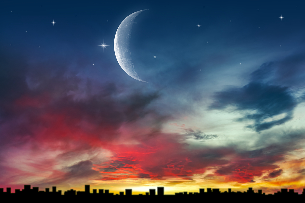 The moon above the city into the sky. background of religions