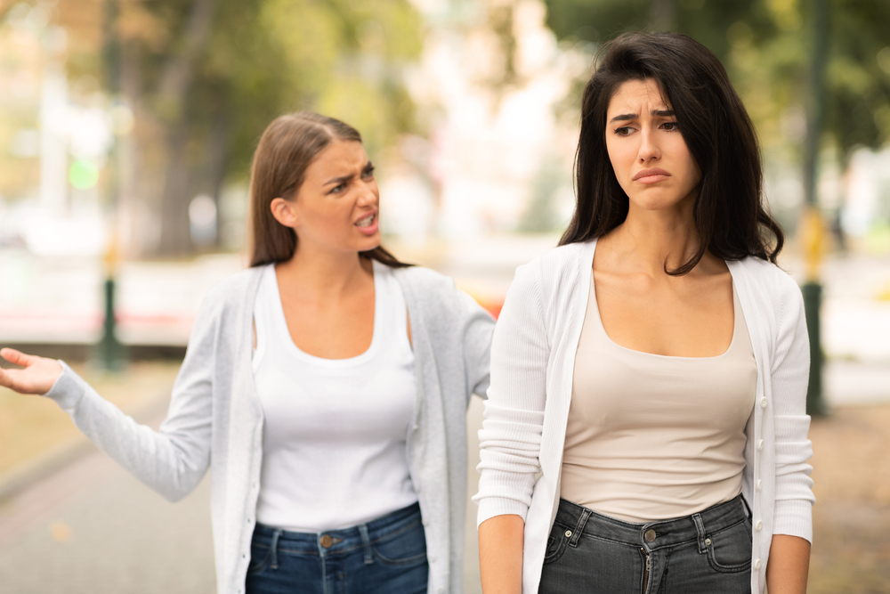 End Of Friendship. Two Girls Friends Having Quarrel Walking In Park Outdoors. Selective Focus