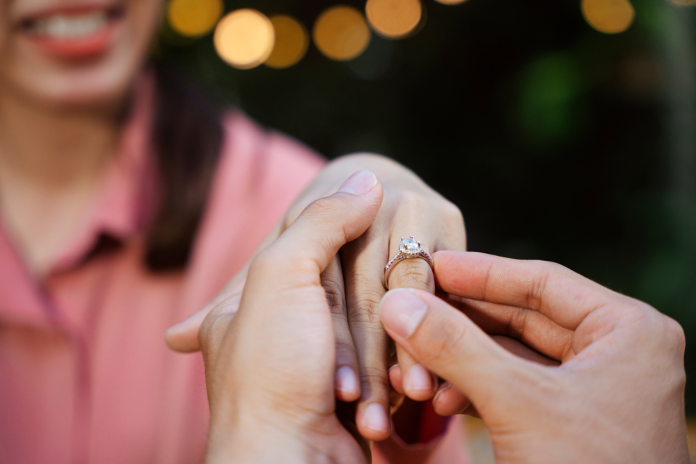 Man propose for marriage with engagement ring.
