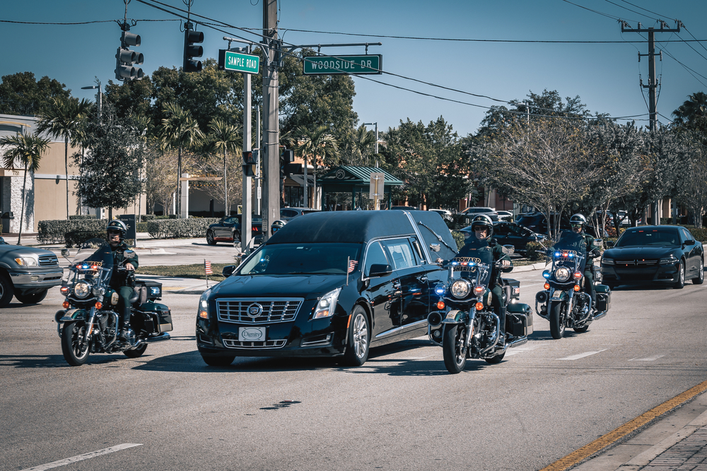 Coral Springs, Florida, USA - February 05, 2021:Funeral procession, cortege from a funeral home to the cemetery. Funeral Police cortege.
