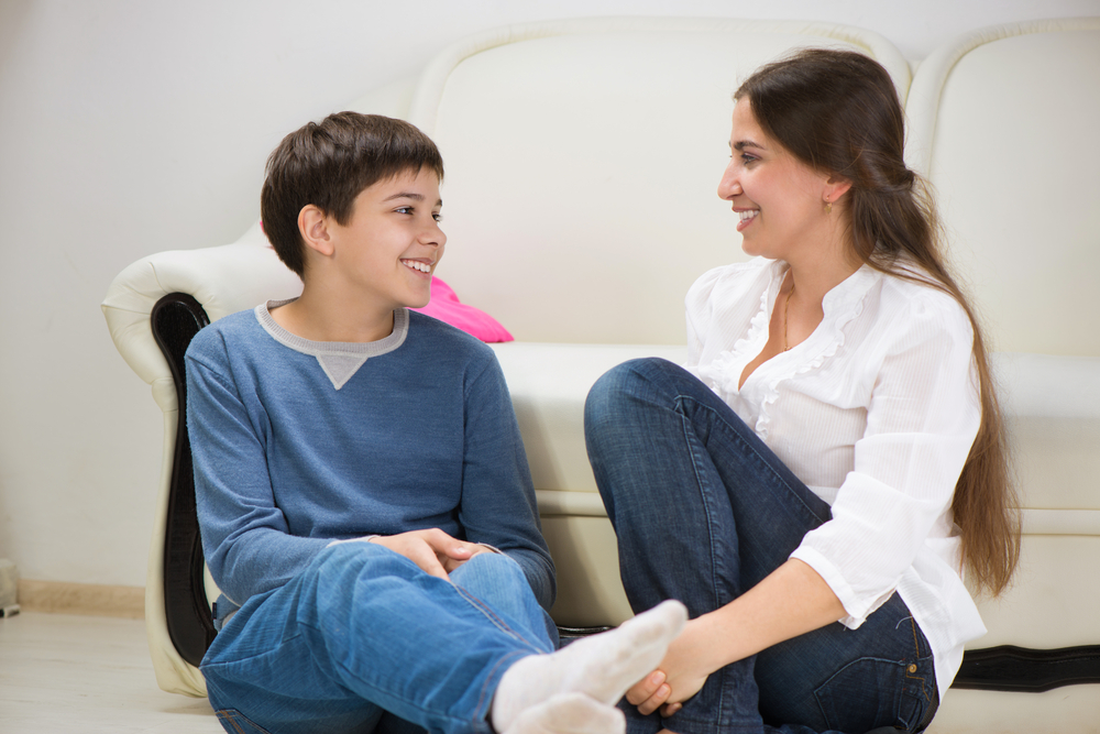 Cute teen boy with his young mother at home
