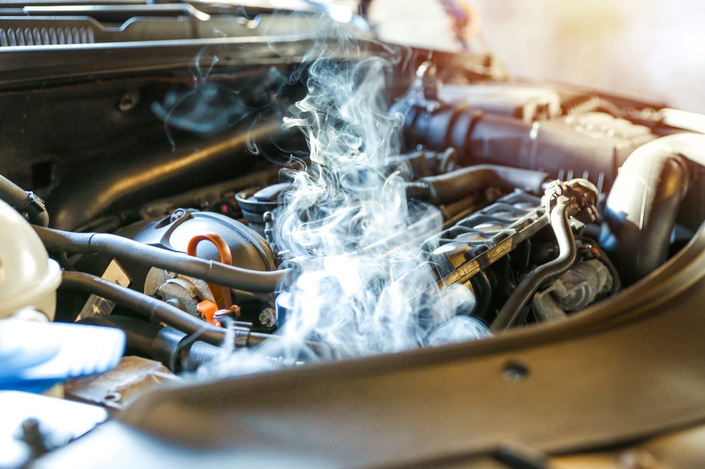 car engine overheating close up. vehicle engine in smoke. smoke or steam from a vehicle engine
