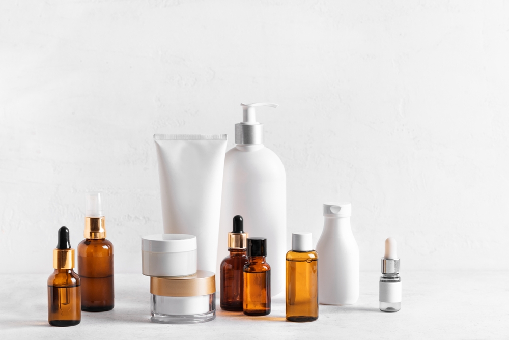 Skincare Beauty Products on white table, assortment of cosmetics bottles and tubes, healthy cosmetology, spa treatment concept, copy space.
