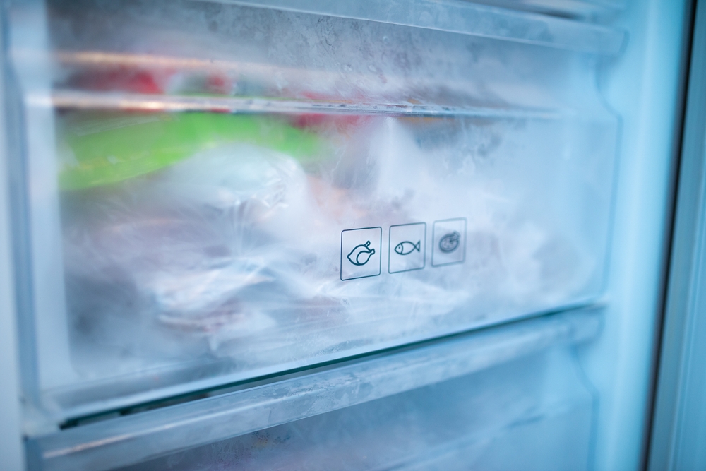 Freezer drawers with chicken, fish and pizza logo in front of drawers.
