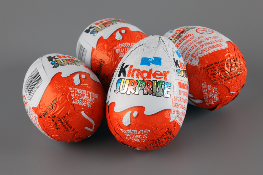 Tambov, Russian Federation - April 04, 2013: Four Kinder Surprise Eggs on grey background. Each Kinder Surprise egg consists of a chocolate shell, a plastic capsule with toy, and external foil wrap.
