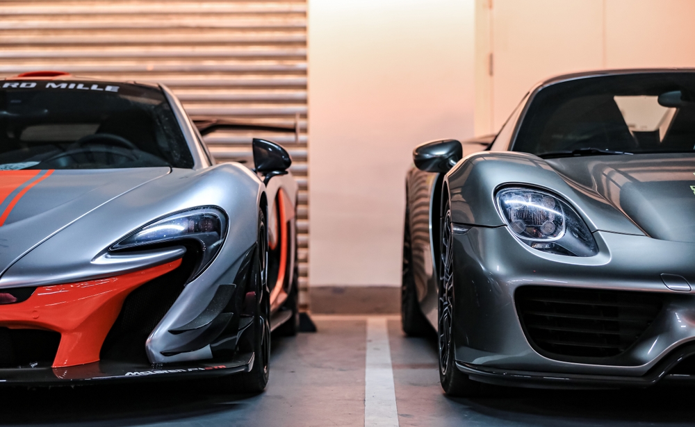 Shanghai, China- February 18, 2023: A silver McLaren P1 with GTR kit and a grey Porsche 918 spyder hypercars are parked in garage
