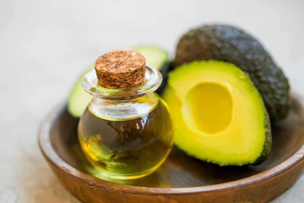 Avocado oil, raw healthy organic avocado oil with avocado fruits
