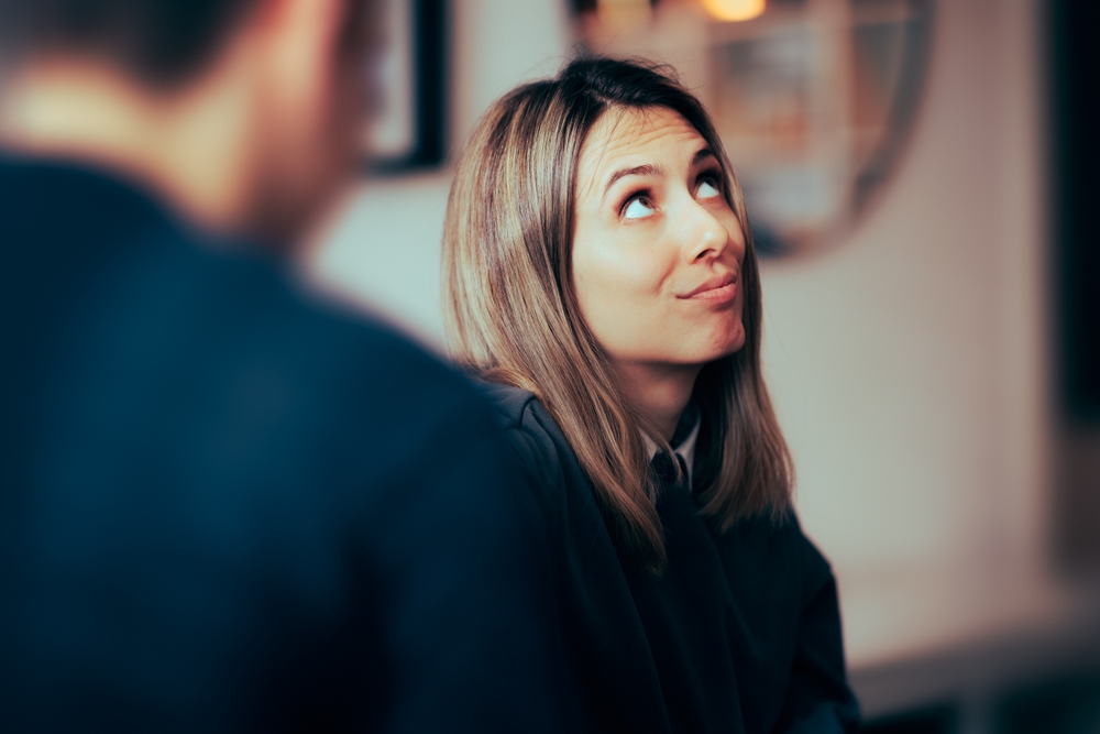 Funny Woman Feeling Bored Talking to her Boyfriend. Wife rolling her eyes at her husband arguments