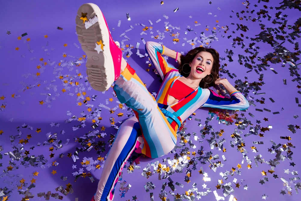 High angle photo of cool funky lady wear striped overall lying floor enjoying discotheque isolated purple color background
