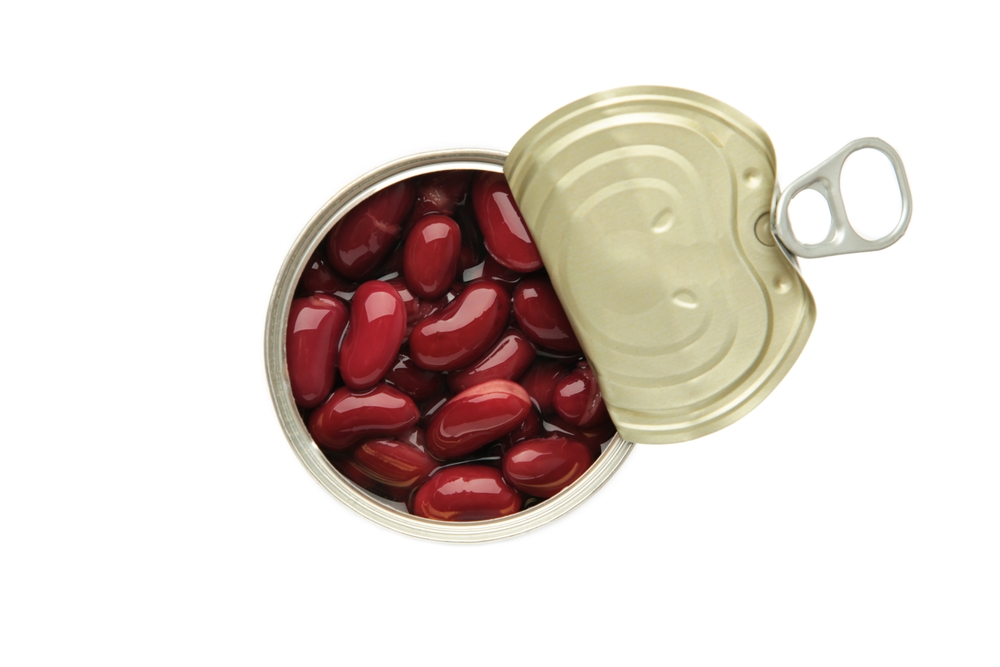 Red kidney beans, in an opened can. Cooked and canned common kidney beans isolated on white background
