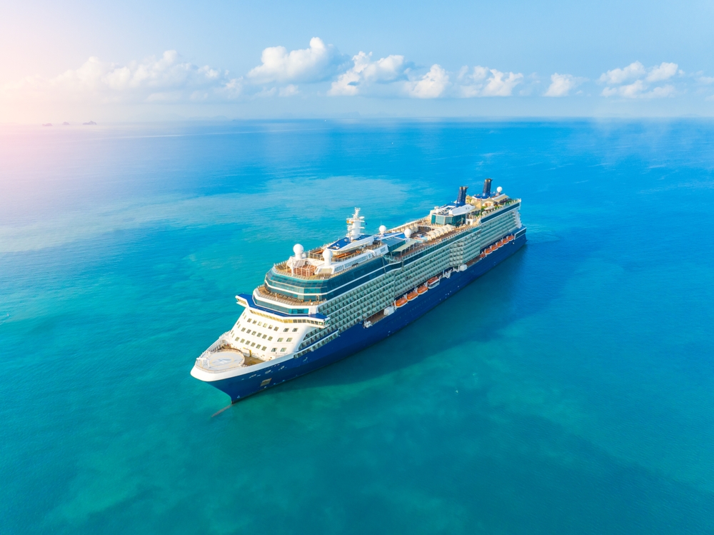 Concept for vacation and travel with a generic cruise ship sailing over the calm ocean. Luxury cruise. 