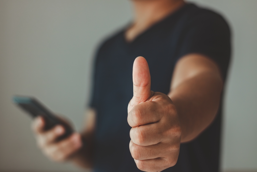 Customer service satisfaction concept. Hand with ok sign gesture thumb up, Positive emotion smile for approval, recommending, like, satisfied, good, best, feedback, standing over white background.
