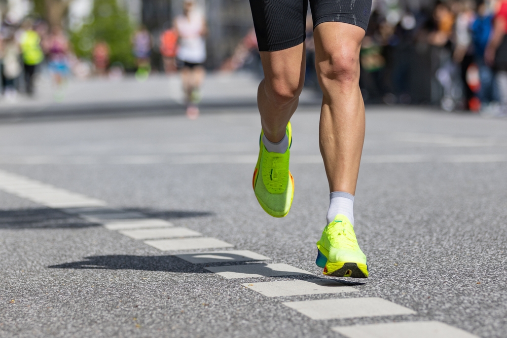 marathon runner with yellow running shoes
