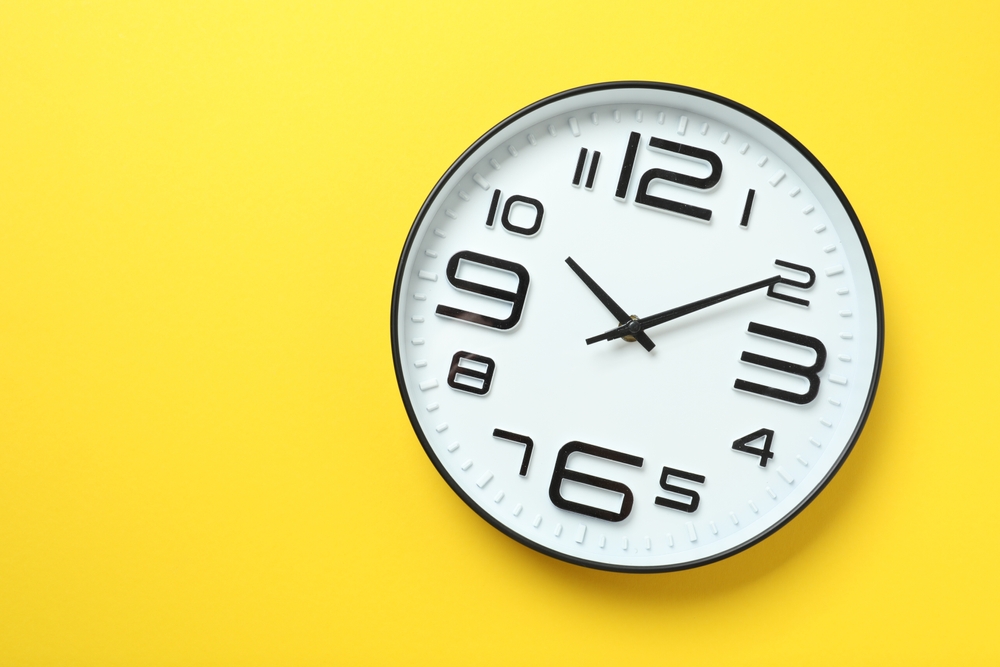 Big beautiful stylish clock on color background