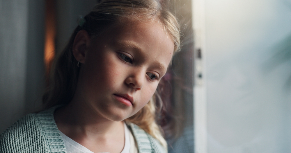 Anxiety, thinking and window with child in home for mental health, adoption crisis or stress. Mistake, foster care trauma and abandon fear with girl at house for sad, reflection and depression