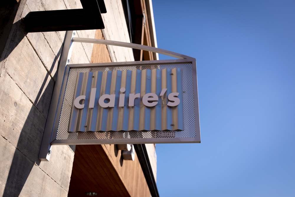 Bend, Oregon US - June 8, 2025: Calire's logo sign on its store brick facade in Old Mill District, Bend, an American retailer of accessories, jewelry, and toys primarily aimed towards teen girls.

