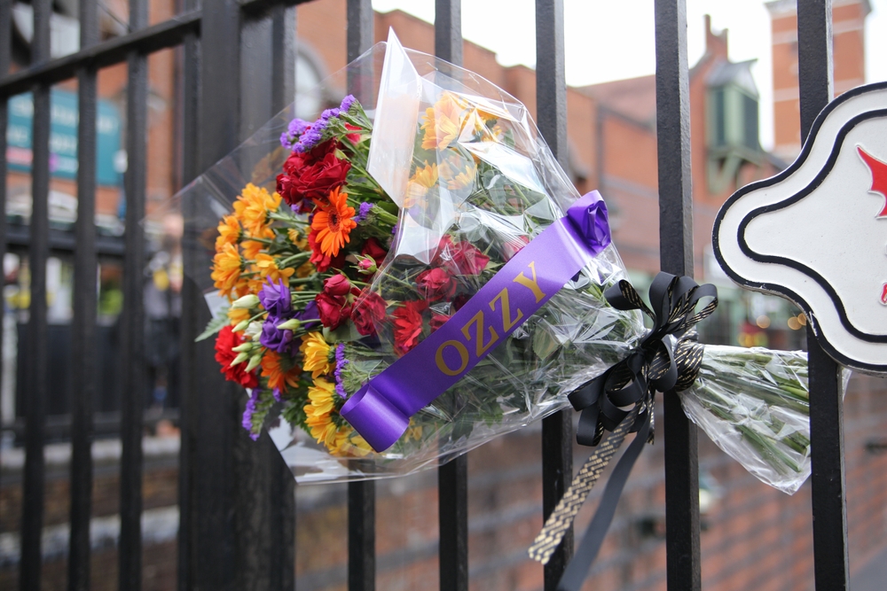 Birmingham, UK. 23rd July, 2025. Fans gather in the city at Black Sabbath Bridge, to pay their respects and lay floral tributes, in memory of Rock Legend Ozzy Osbourne, who passed away on Tuesday.
