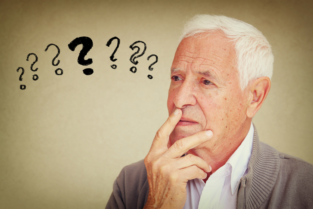 image of senior man thinking with set of question marks icons
