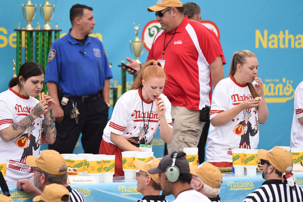 NEW YORK CITY - JULY 4 2015: Nathan's Famous staged its annual fourth of July hot dog eating contest in Coney Island, Brooklyn. Women's division competitors
