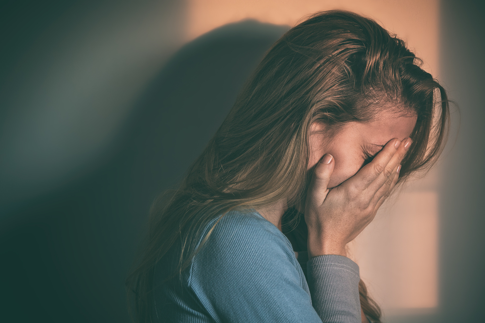 A woman sitting alone and depressed. Regretting.