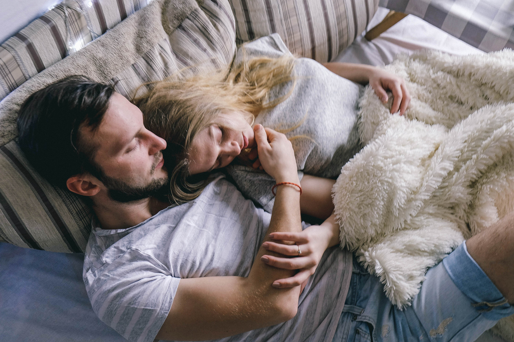 young beautiful couple embracing in bed