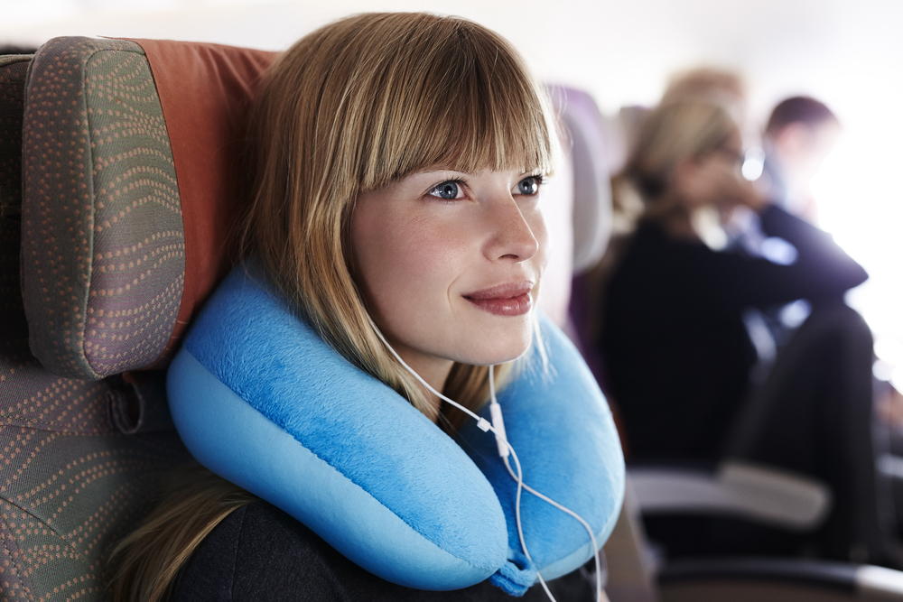 Beautiful female passenger on airplane
