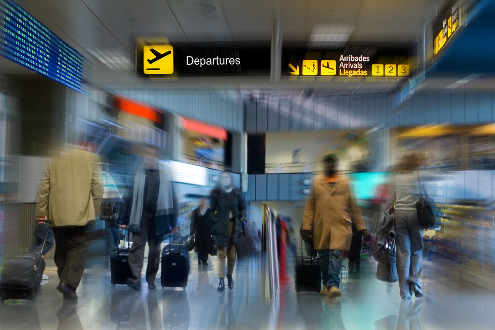 Airline passengers walking in the airport terminal