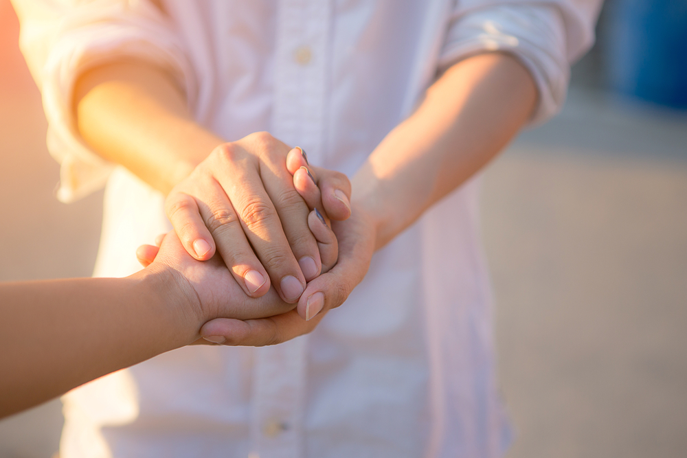 Man and woman holding hands closeup
