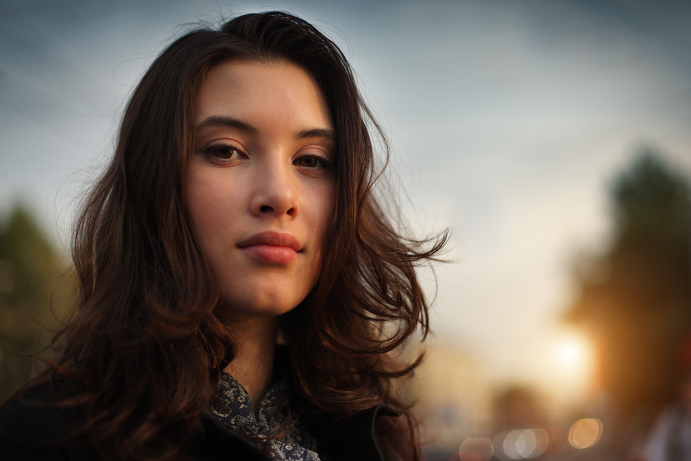 Portrait of beautiful Asian woman in city, closeup on face.