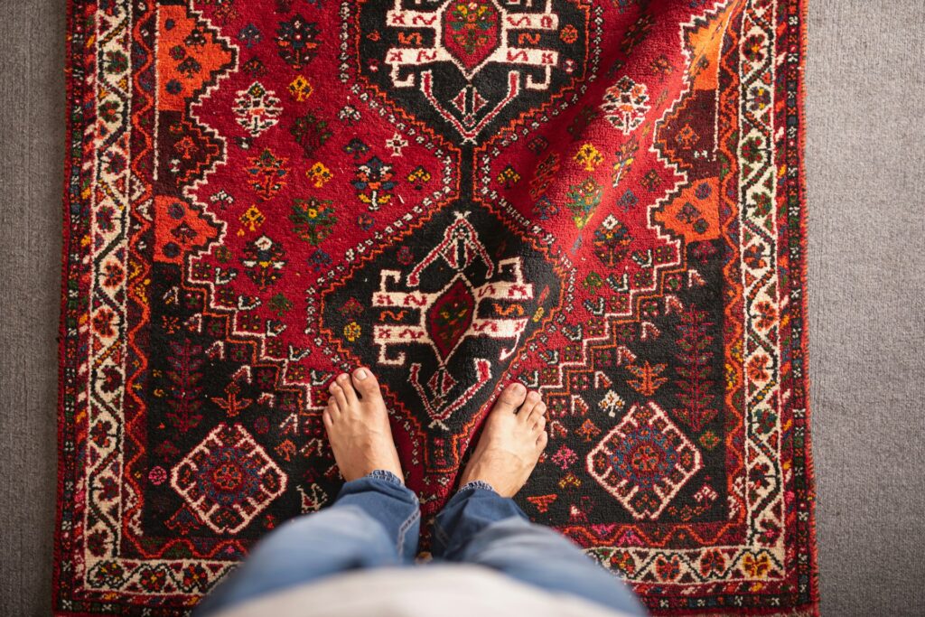 a person standing in front of a rug
