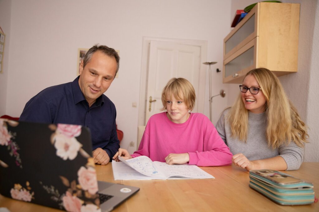 woman in blue shirt beside girl in pink shirt
