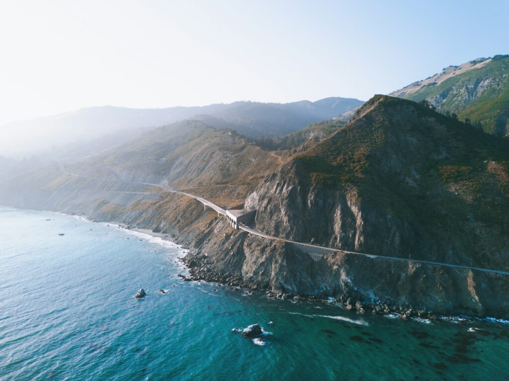 aerial view photography of mountain near body of water
