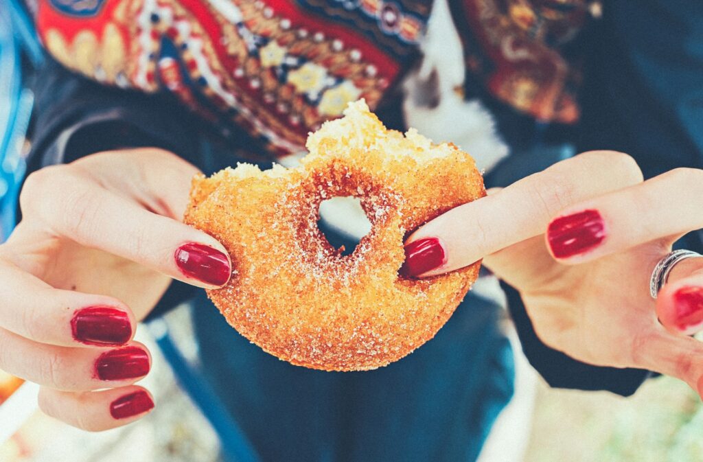 woman holding donut
