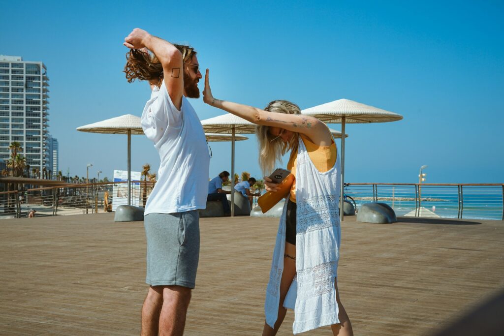 woman standing in front of man during daytime
